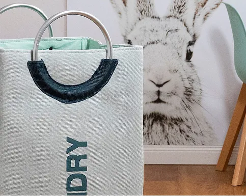 DRY Laundry Basket Cotton Storage Bin Beige laundry basket with dark blue handles and "DRY" text next to rabbit poster on wall