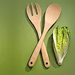 Nachhaltiges Holzbesteck Set – umweltfreundliches Einwegbesteck Holzbesteck-Set mit Gabel, Löffel und Messer auf grünem Hintergrund