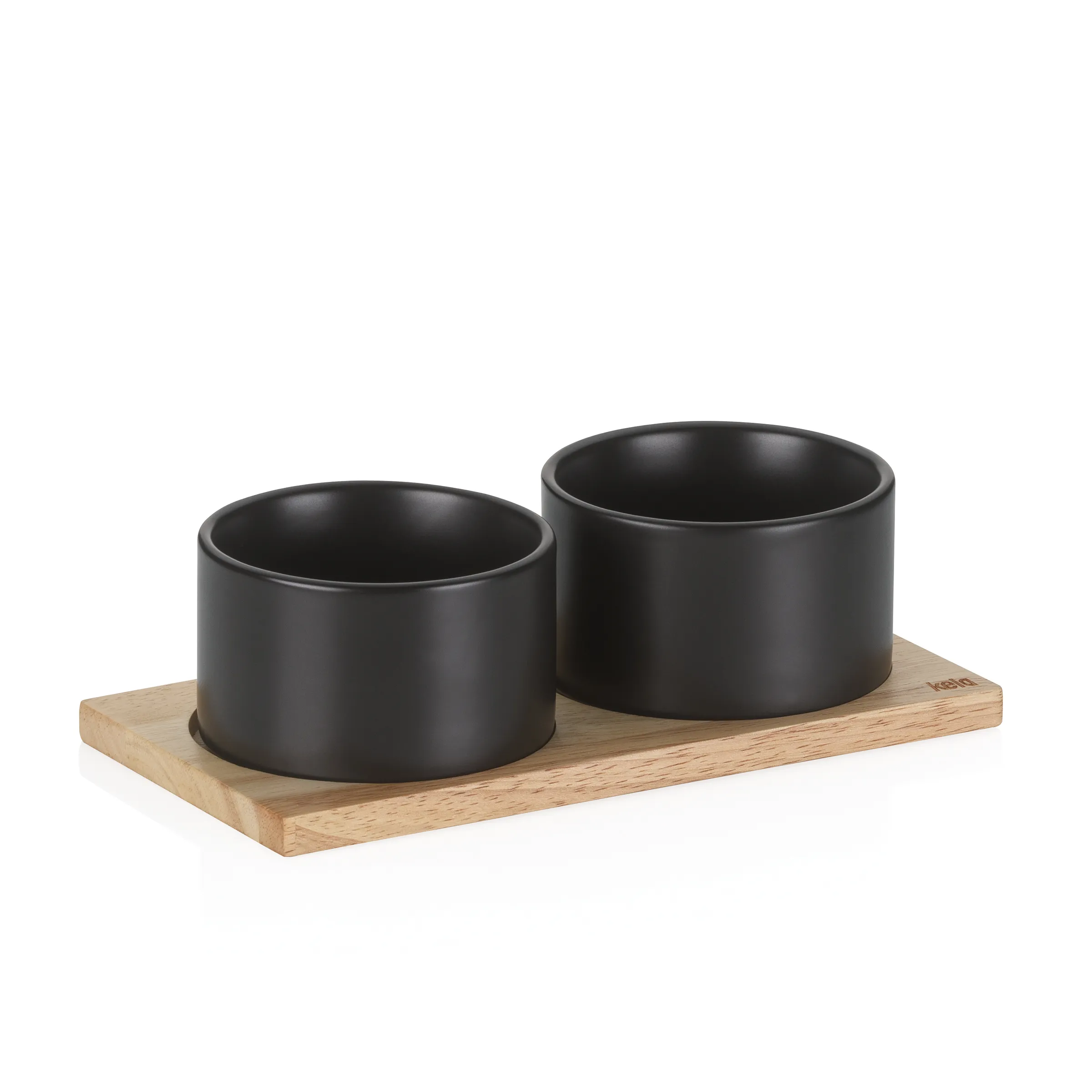 Zwei schwarze Keramikschalen auf einem Holzbrett nebeneinander angeordnet