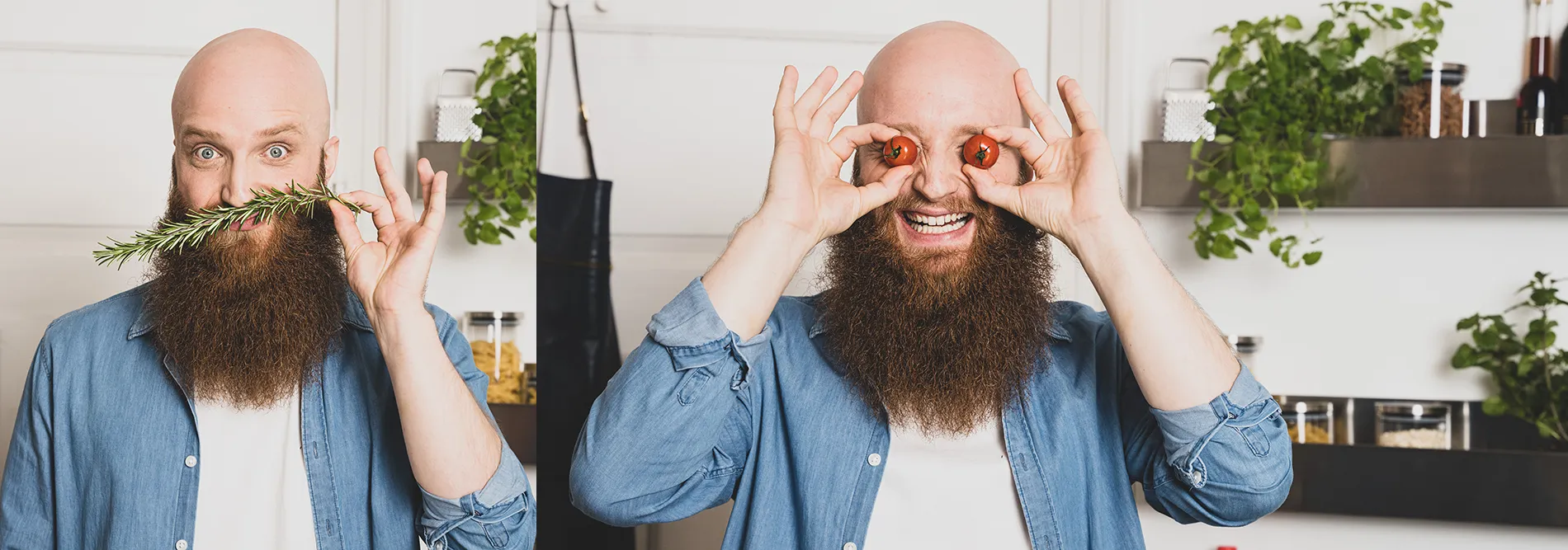 Bärtiger Mann in Jeans-Hemd macht humorvolle Gesten mit Rosmarinzweig und Händen vor Gesicht in moderner Küche