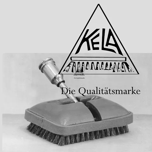 Kella Scheuerbürste Qualitätsmarke Reinigung Kella Scheuerbürste mit Spray-Aufsatz auf grauem Untergrund, mit Kella-Logo und Schriftzug „Die Qualitätsmarke