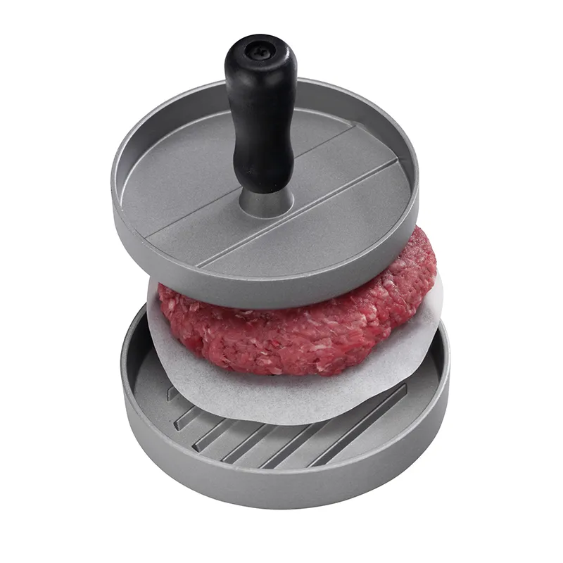 Burgerpresse Aluminium - Hamburger Pattypresse für perfekte Burger Burgerpresse aus Aluminium mit schwarzem Griff, rohem Hackfleisch-Patty und Antihaftpapier