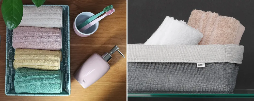 Handtücher Set Badezimmer Accessoires Ordentlich gefaltete Handtücher in verschiedenen Farben in einer grünen Schachtel neben Seife und Zahnbürste