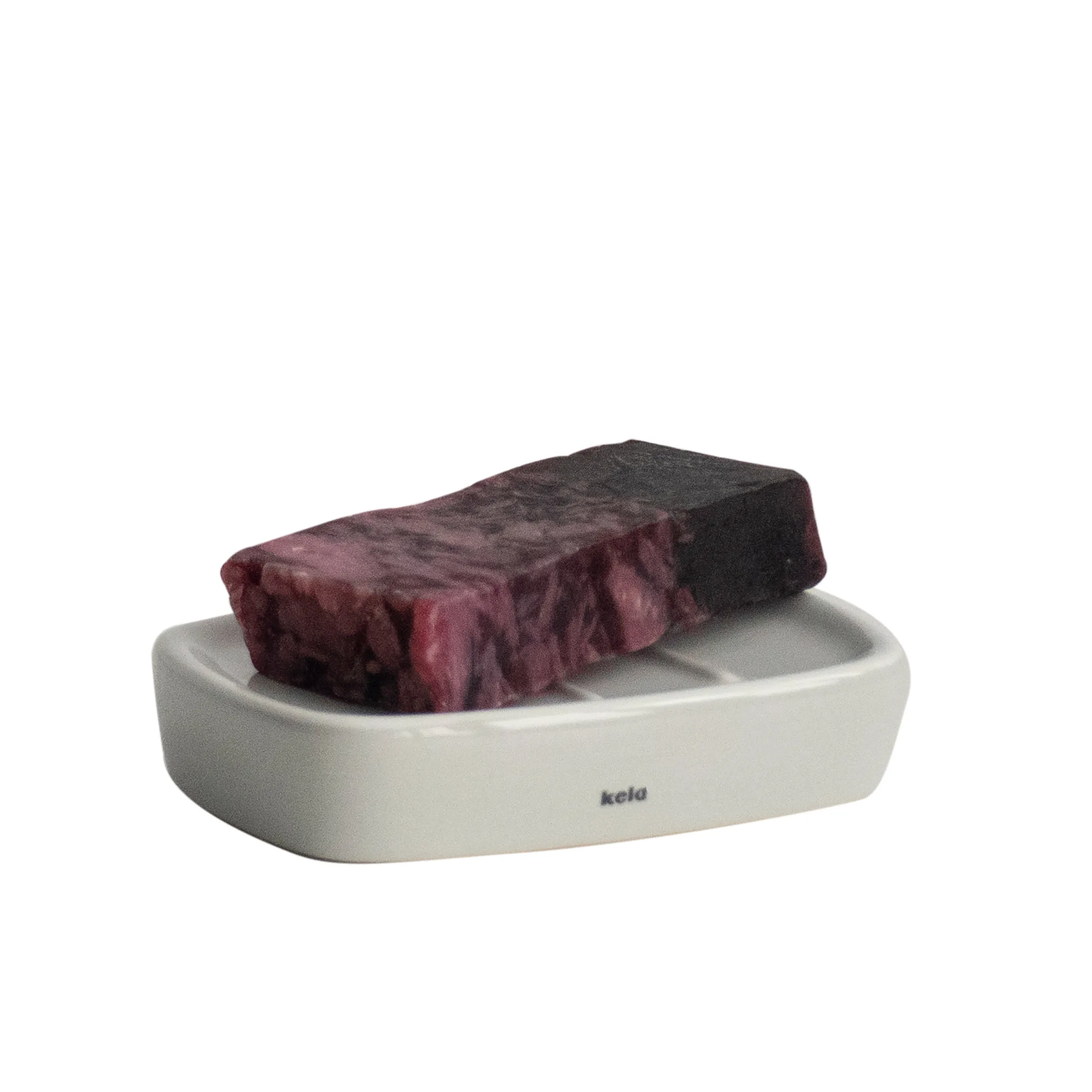 Keramik Seifenschale - Moderne Badezimmer Accessoires Weiße Keramik-Seifenschale mit burgundy-farbenem Tuch und schwarzem Stein