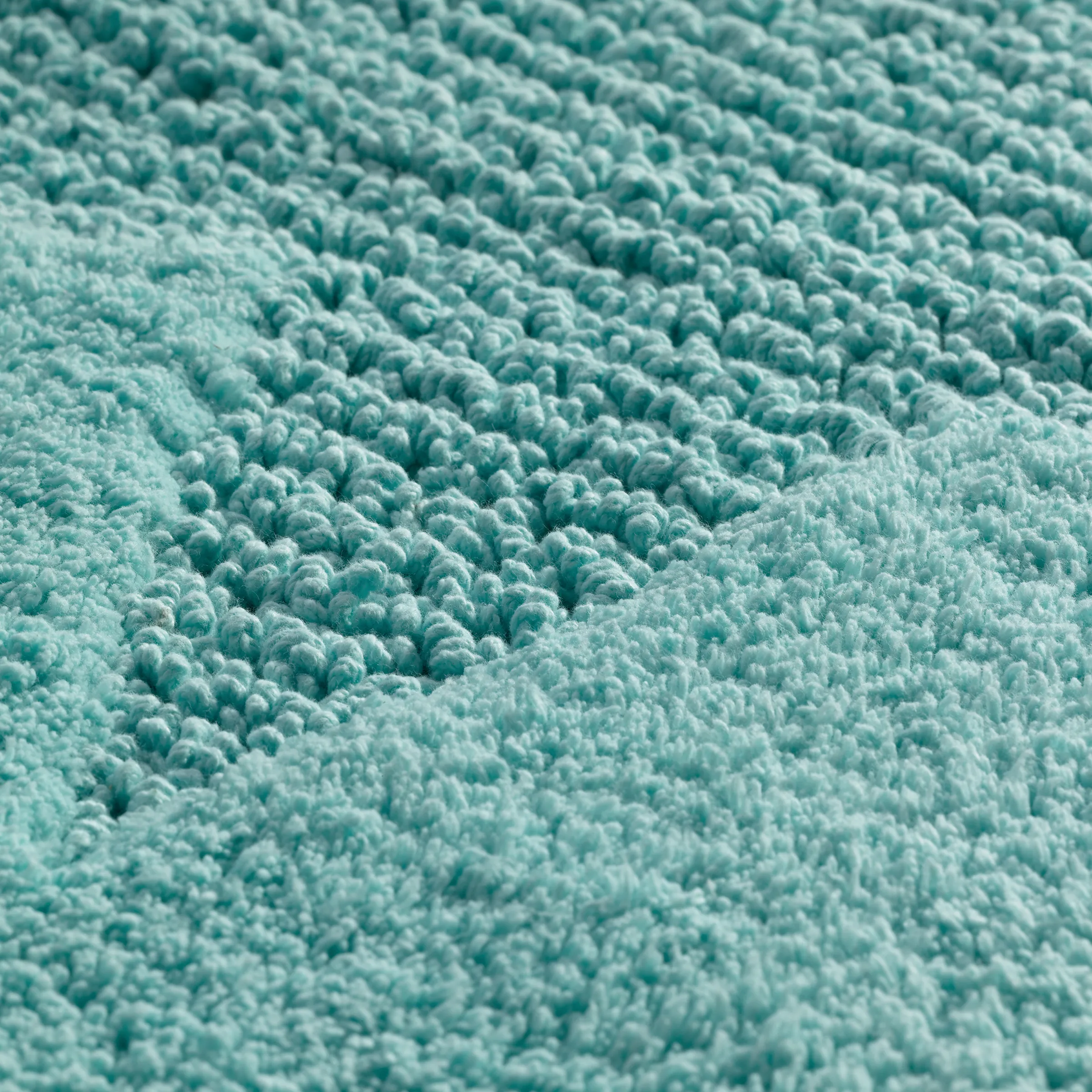Türkises Frottee-Handtuch Nahaufnahme - weiche Baumwoll-Textur Nahaufnahme einer türkisfarbenen Handtuch-Textur mit weichen, flauschigen Frottee-Schlingen
