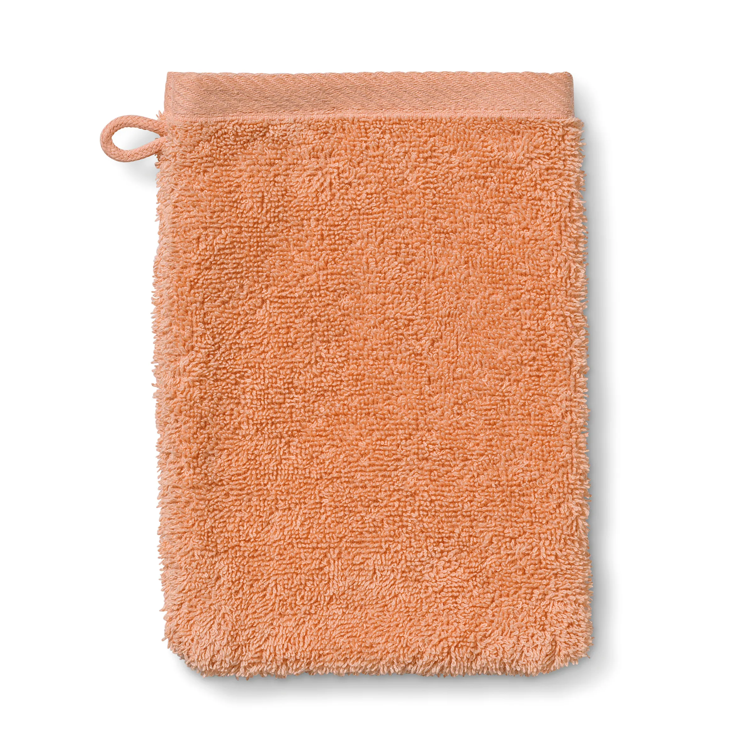 Waschlappen Frottee apricot - hochwertige Badtextilien Apricot-farbener Waschlappen aus Frottee mit einer Schlaufe zum Aufhängen an der oberen linken Ecke.
