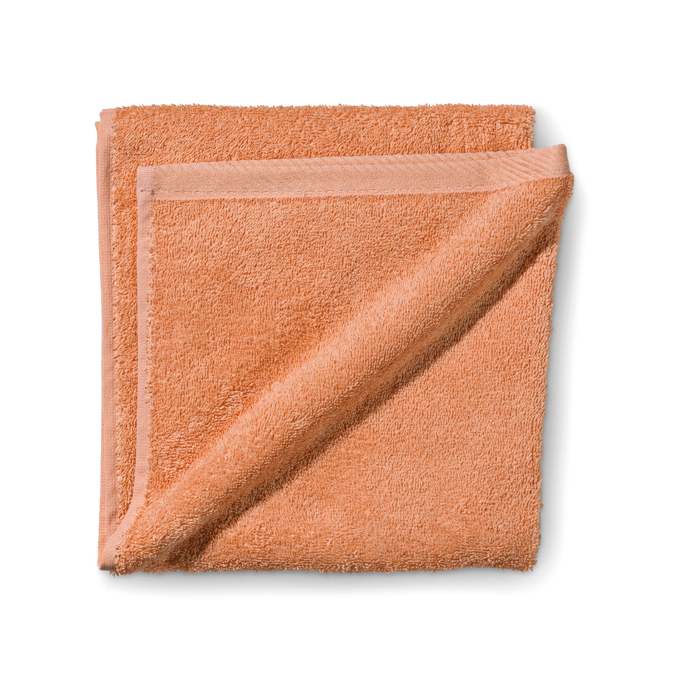 Frotteetücher Apricot - Weiche Handtücher in Orange Zwei gefaltete Frotteetücher in warmem Apricot-Orange übereinander gelegt auf weißem Hintergrund