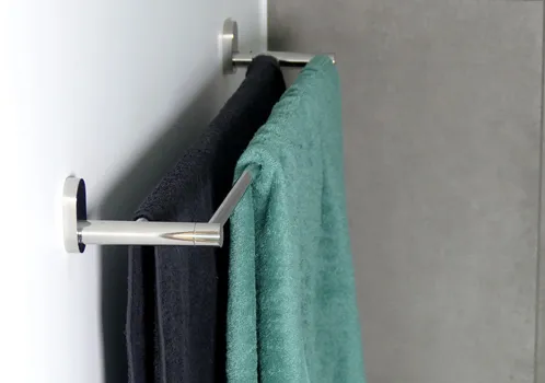Handtuchhalter Wandmontage mit Handtüchern Moderner Handtuchhalter an weißer Wand mit grauem und türkisfarbenem Handtuch
