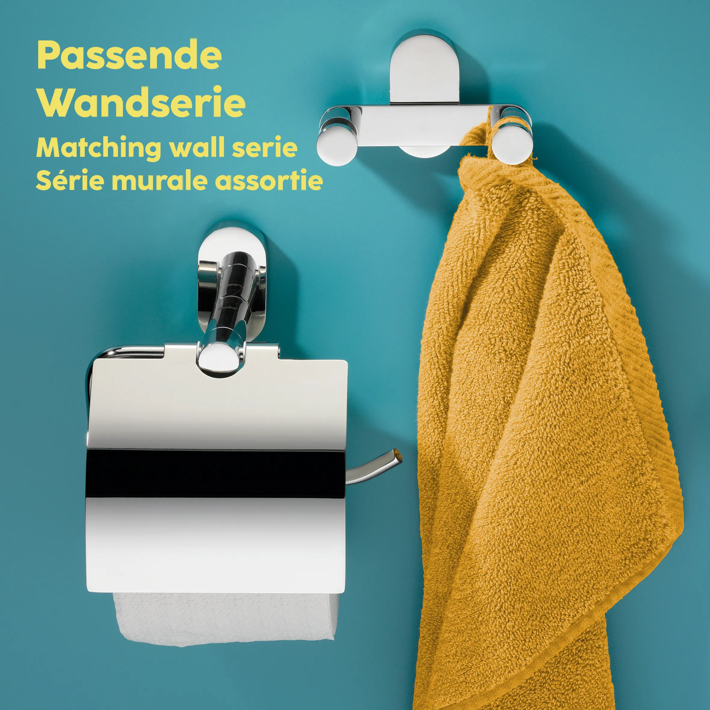 Passende Badezimmer-Wandserie: Toilettenpapierhalter und Handtuchhaken Badezimmer-Wandserie mit Toilettenpapierhalter, Handtuchhaken und Seifenspender aus Metall auf türkisem Hintergrund