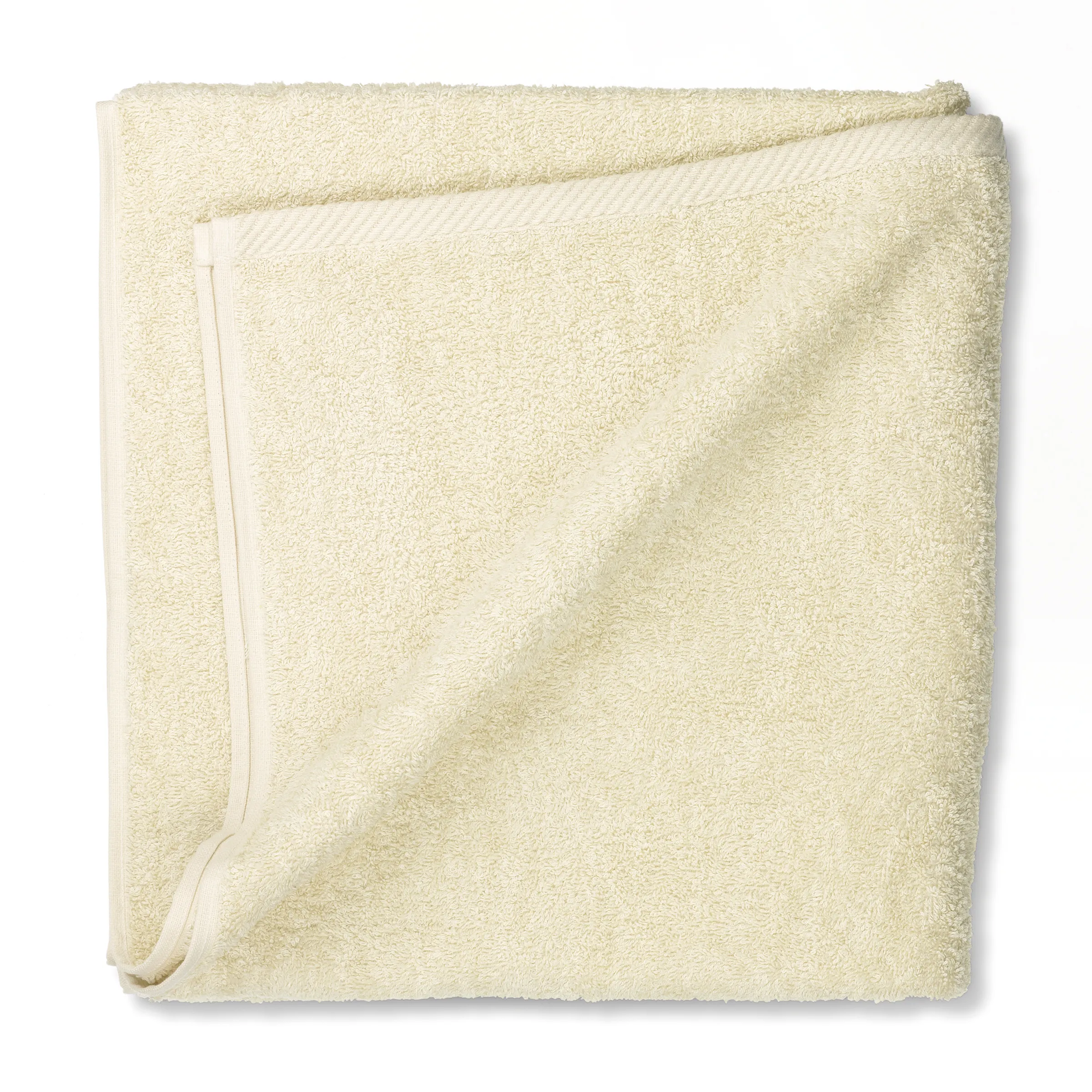 Premium Handtuch Frottee elfenbeinfarben Elfenbeinfarbenes Handtuch aus Frottee, gefaltet und übereinandergelegt, mit feiner Textur und Saum