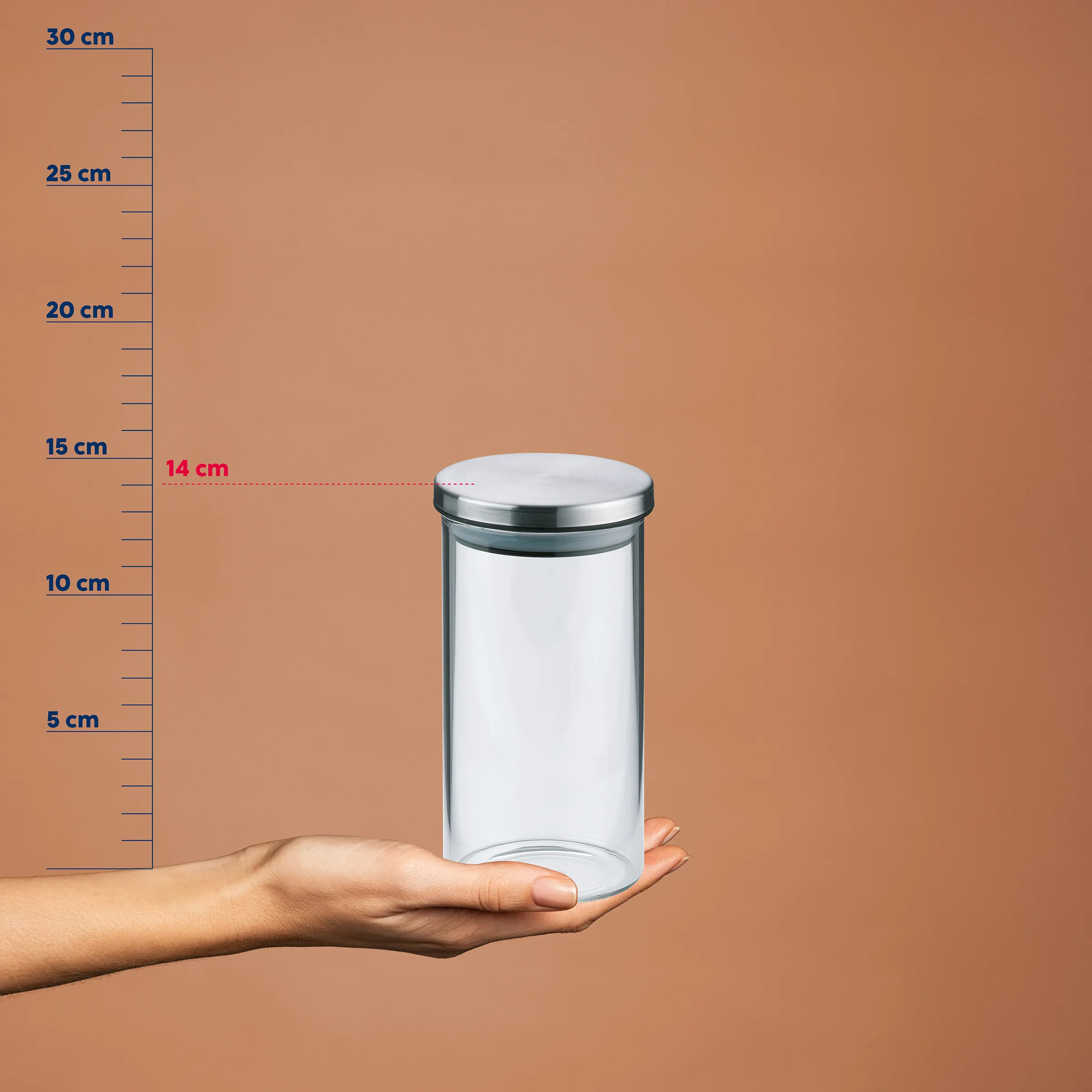 Vorratsglas mit Metalldeckel – Aufbewahrungsbehälter Klares Glasgefäß mit Metalldeckel in einer Hand vor Größenvergleichsskala, etwa 14 cm Durchmesser und 15 cm Höhe
