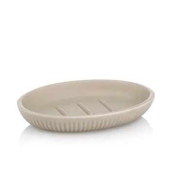 Ovale beige Seifenschale aus Keramik mit gerilltem Rand und Wasserablaufrillen im Inneren