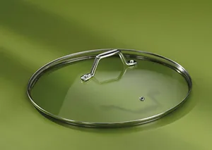 Glasdeckel mit Dampföffnung - Topfdeckel Küchengeschirr Gläserner Topfdeckel mit Metallgriff und Dampföffnung auf grünem Hintergrund