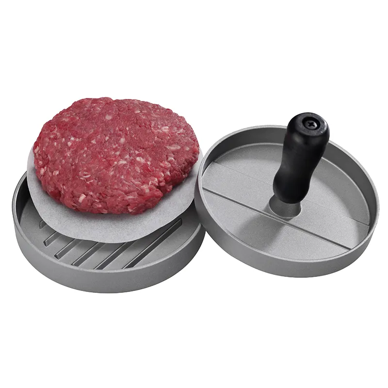 Burgerpresse Hamburger-Presse Set mit Antihaftbeschichtung für perfekte Burger-Patties Burgerpresse aus Metall mit schwarzem Griff und geformtem rohem Fleischpatty auf Backpapier
