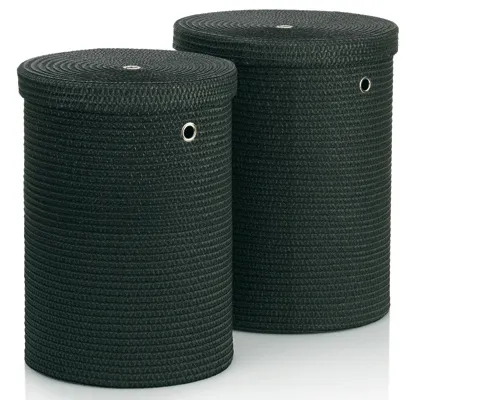 Two dark green cylindrical woven storage baskets with lids and metal grommets for organization.